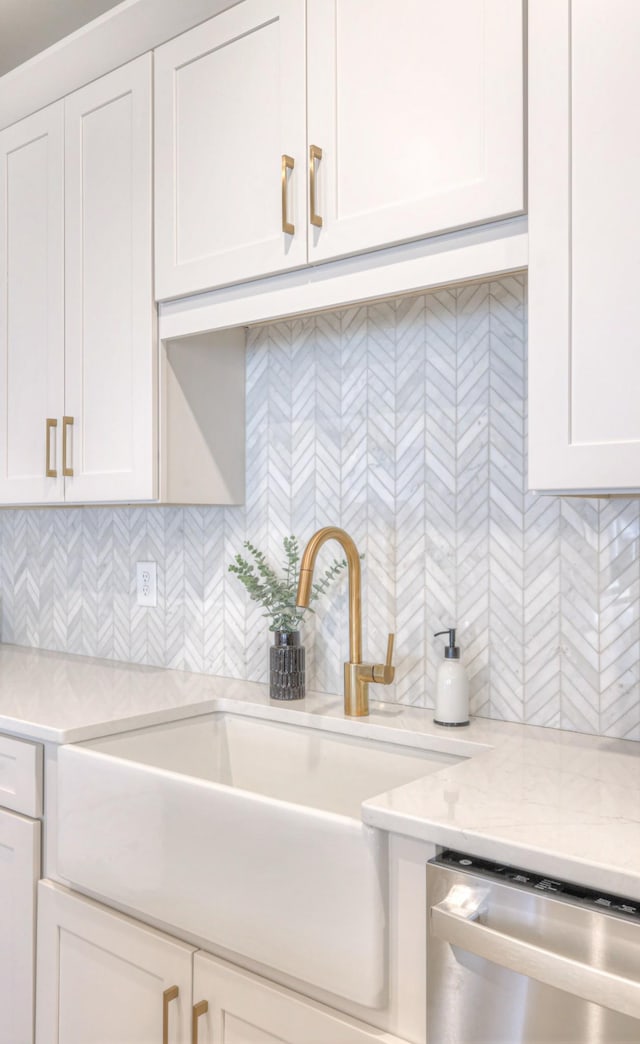 kitchen with decorative backsplash, dishwasher, light countertops, and a sink