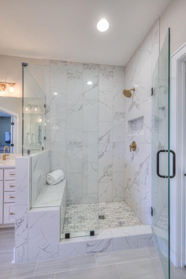 bathroom with vanity and a shower stall