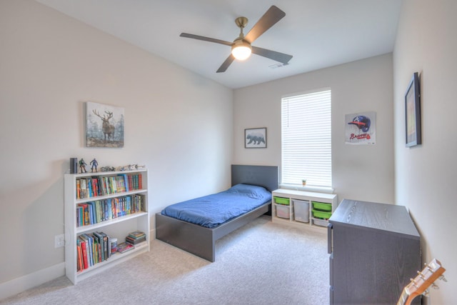 carpeted bedroom with a ceiling fan, visible vents, and baseboards