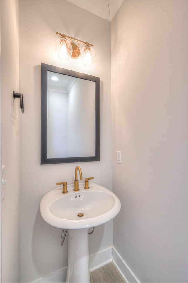 bathroom featuring baseboards and wood finished floors