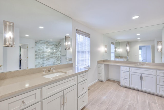 bathroom with a sink, wood finished floors, a stall shower, and recessed lighting