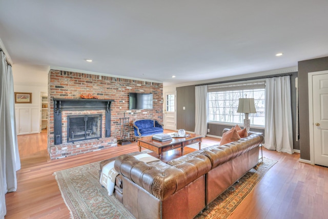 living area featuring a fireplace, recessed lighting, and wood finished floors