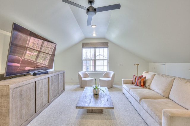 living room with baseboards, light carpet, a ceiling fan, and vaulted ceiling