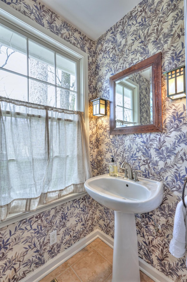 bathroom with a wealth of natural light, baseboards, tile patterned flooring, and wallpapered walls