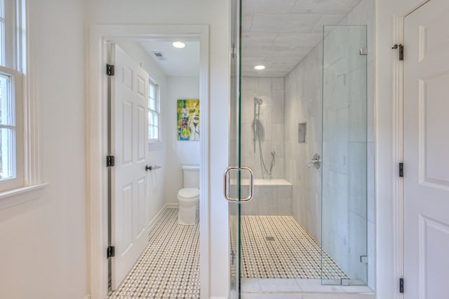 full bath featuring visible vents, plenty of natural light, toilet, and a shower stall