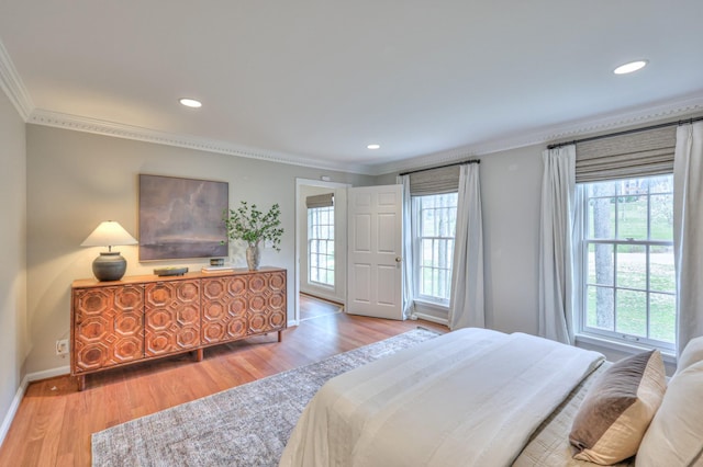 bedroom with recessed lighting, wood finished floors, baseboards, and ornamental molding