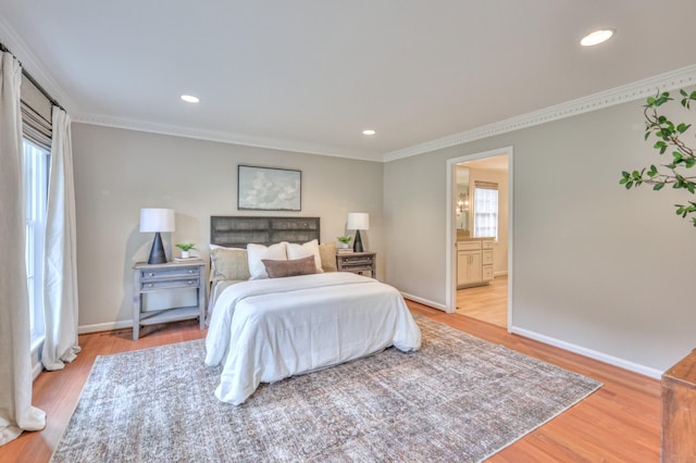 bedroom featuring recessed lighting, baseboards, crown molding, and light wood finished floors