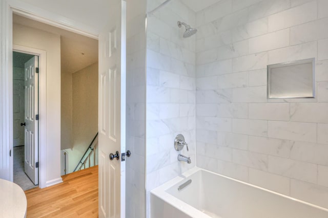 full bath featuring shower / bathing tub combination and wood finished floors