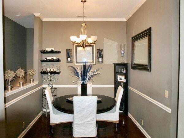 dining area with wood finished floors, baseboards, a chandelier, and ornamental molding