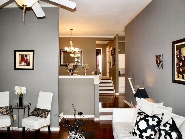 interior space featuring ceiling fan with notable chandelier, crown molding, wood finished floors, and baseboards