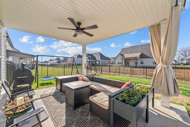 view of patio / terrace featuring ceiling fan, a fenced backyard, a residential view, and an outdoor hangout area