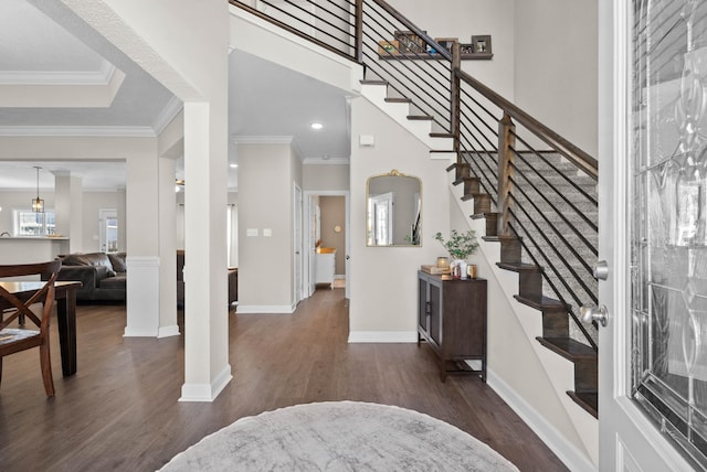 entryway featuring dark wood-style floors, stairs, crown molding, and baseboards