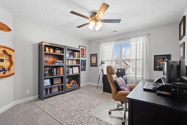 home office featuring light carpet, baseboards, and ceiling fan