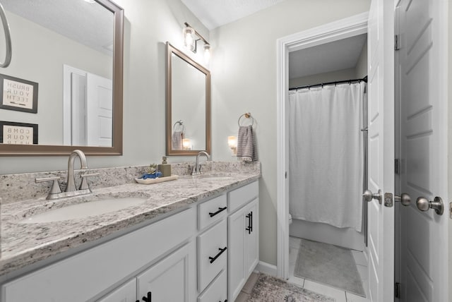 full bathroom featuring double vanity, a shower with shower curtain, and a sink