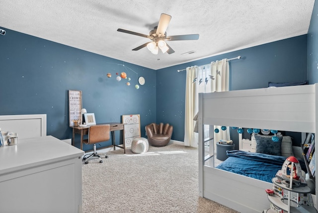 carpeted bedroom featuring visible vents, a textured ceiling, and a ceiling fan