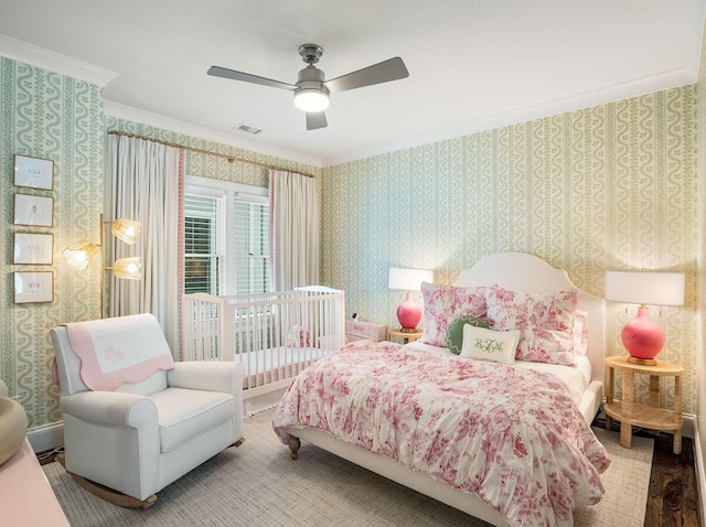 bedroom featuring wallpapered walls, a ceiling fan, visible vents, and ornamental molding