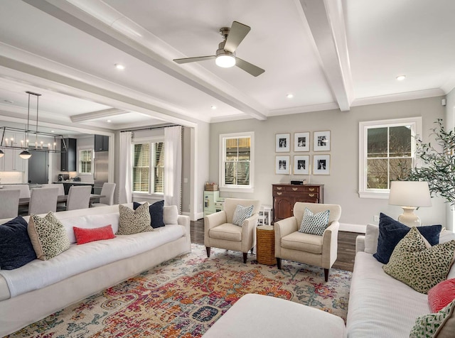 living area featuring baseboards, beamed ceiling, recessed lighting, ceiling fan with notable chandelier, and wood finished floors