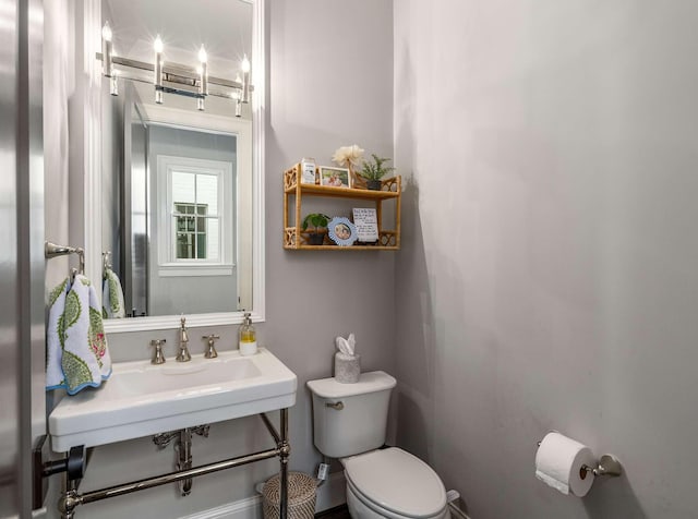 bathroom featuring toilet and a sink