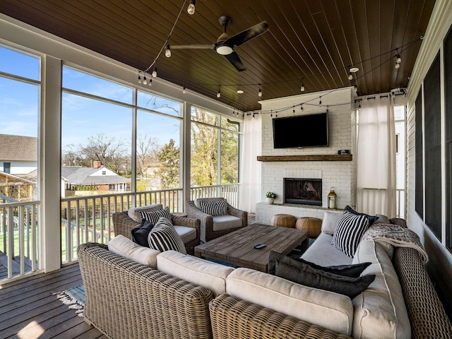 sunroom with wood ceiling, ceiling fan, track lighting, and a healthy amount of sunlight