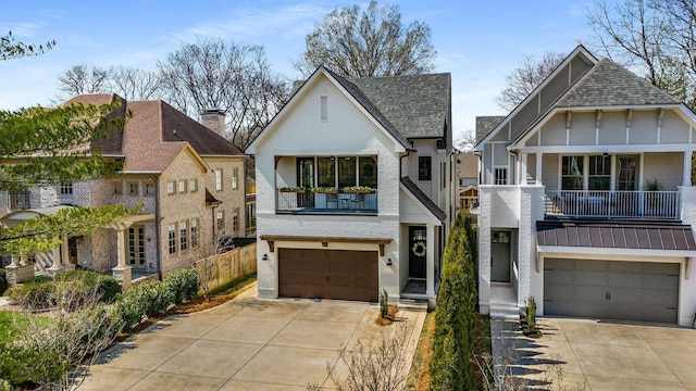 view of front facade with an attached garage, fence, brick siding, and driveway