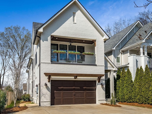 view of front of house with a garage, brick siding, a balcony, and driveway