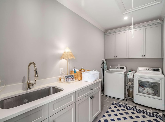 washroom with washer and dryer, a sink, cabinet space, tile patterned flooring, and attic access