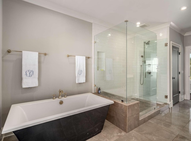 bathroom with marble finish floor, ornamental molding, recessed lighting, a shower stall, and a freestanding bath