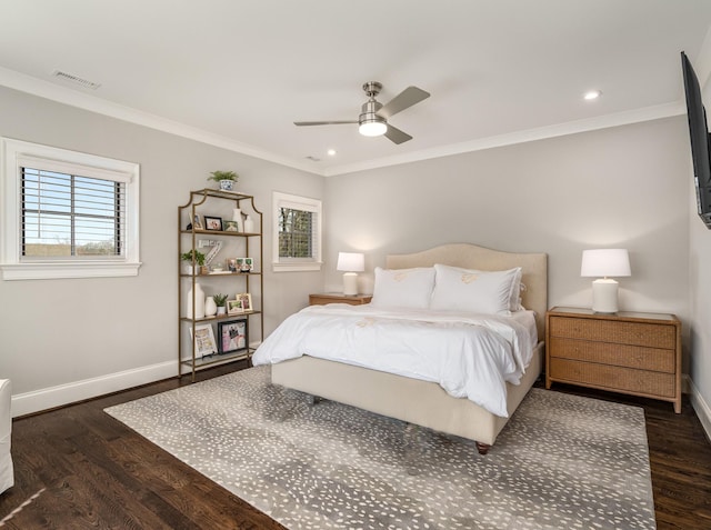 bedroom with visible vents, wood finished floors, baseboards, and ornamental molding