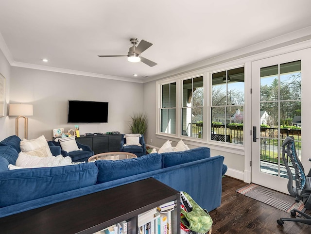 living area featuring baseboards, ornamental molding, recessed lighting, a ceiling fan, and dark wood-style flooring