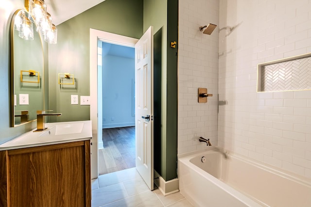 full bath with tile patterned floors, baseboards, shower / bathtub combination, and vanity