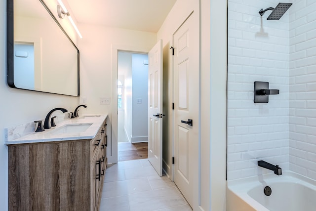 full bathroom with double vanity, shower / bathtub combination, and a sink