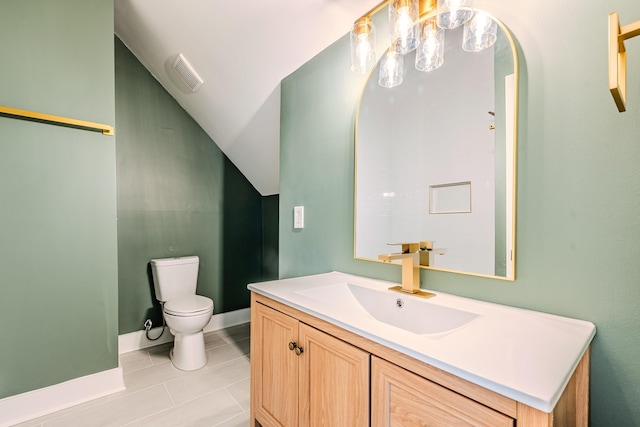 bathroom with vanity, baseboards, visible vents, tile patterned flooring, and toilet