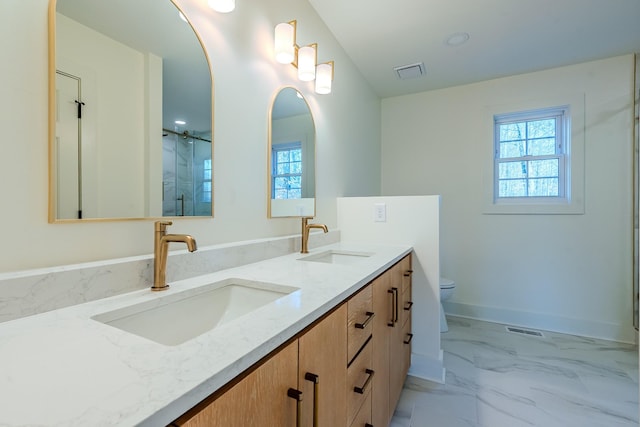 bathroom featuring visible vents, marble finish floor, a wealth of natural light, and a sink