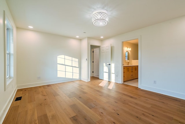 unfurnished bedroom featuring light wood-style flooring, recessed lighting, visible vents, and baseboards