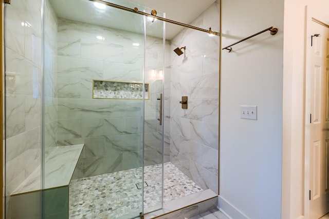 bathroom with baseboards and a stall shower