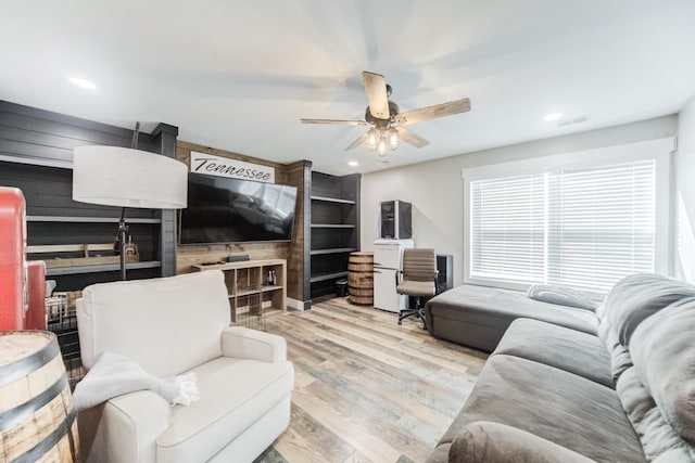 living room with visible vents, recessed lighting, a ceiling fan, and wood finished floors