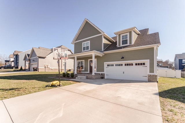 craftsman house with fence, a residential view, concrete driveway, a front yard, and a garage