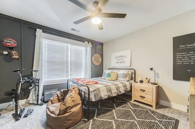 carpeted bedroom with visible vents, a ceiling fan, and baseboards