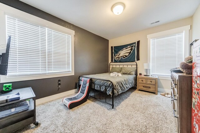 bedroom with visible vents, baseboards, and carpet flooring
