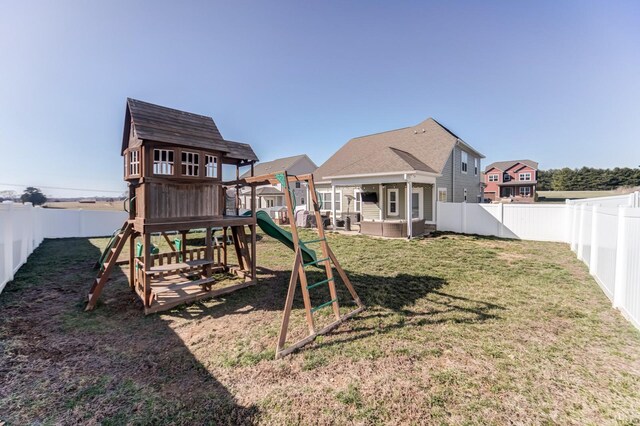 view of play area with a residential view, a lawn, and a fenced backyard