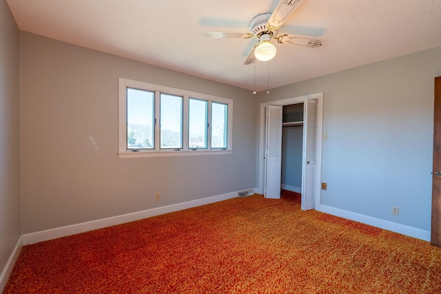 unfurnished bedroom with a closet, baseboards, light colored carpet, and ceiling fan
