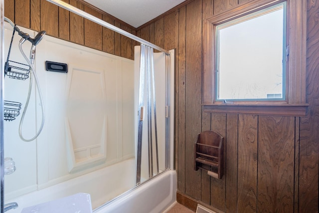 full bath with wood walls and shower / bath combination with glass door
