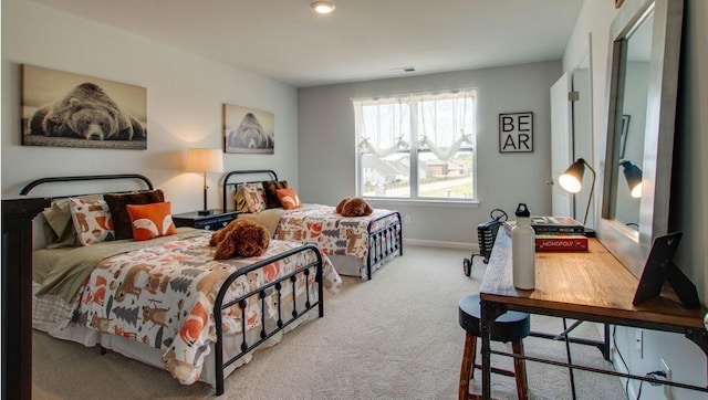 carpeted bedroom with visible vents and baseboards