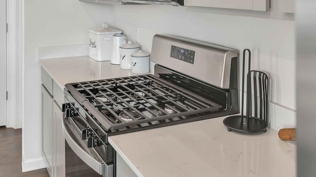 interior details featuring light countertops and stainless steel gas stove