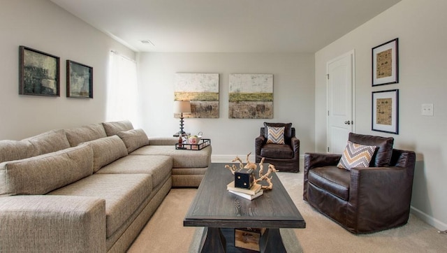 living room with visible vents, baseboards, and light colored carpet