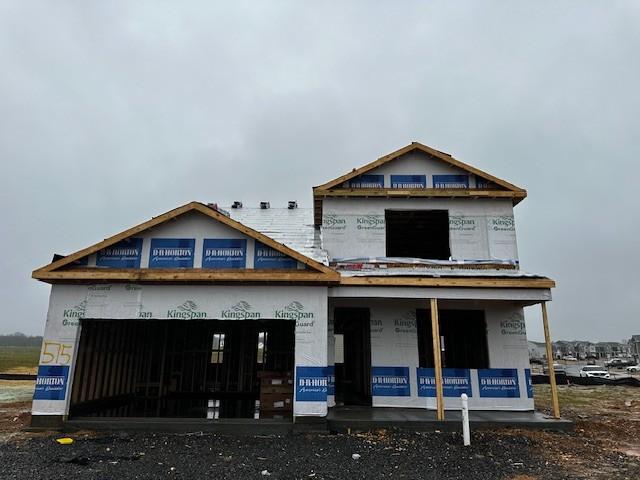 unfinished property featuring an attached garage