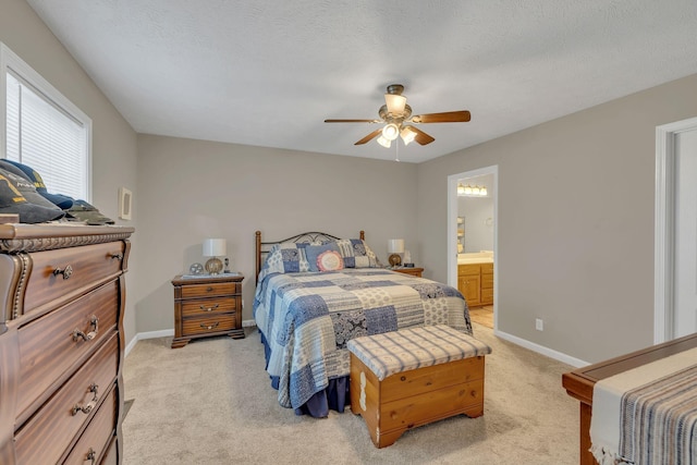 bedroom featuring baseboards, light carpet, a textured ceiling, and ceiling fan