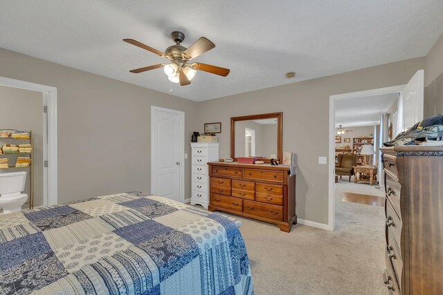 bedroom with light colored carpet, baseboards, and ceiling fan