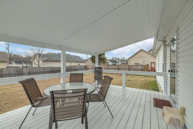 deck with outdoor dining area and a fenced backyard