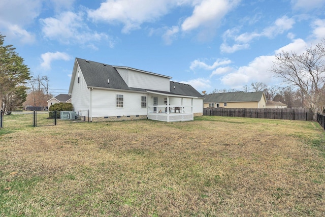 rear view of house with a gate, a fenced backyard, a yard, and crawl space